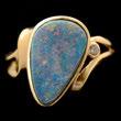 Featuring one oval opal cabochon measuring approximately 10 x 7 mm, surrounded by eighteen full-cut diamonds, set in a 14k yellow gold mounting. {Size 7, Gross Weight: 2.