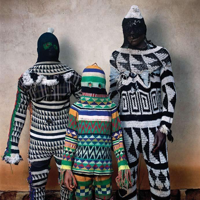 The patterns are secret society symbols. Ekpe Ekpe means leopard." Over a full-body suit of crocheted rope, a colorful cloud of naturally dyed raffia hangs around the body.