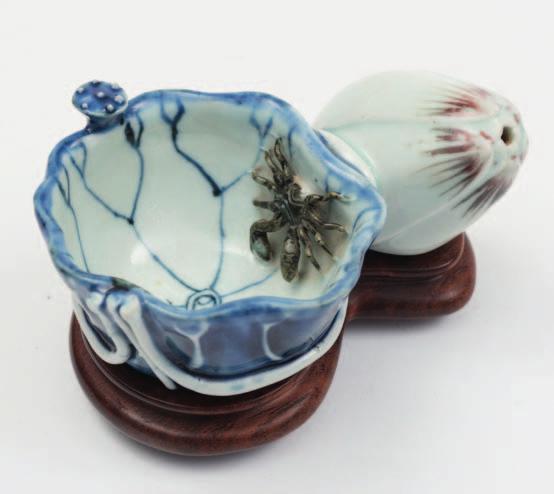 511 A Chinese underglaze blue and copper-red lotus waterdropper formed as a lotus leaf with attached seed-pod, the leaf with painted and applied veins and stems, a crab with sepia markings climbing