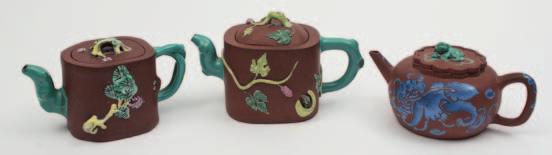 100-200 566 570 568 Two Chinese Yixing teapots and covers the first with imitation bamboo spout, handle and cover, decorated and incised with calligraphy and foliage, impressed seal mark, 11cm high;