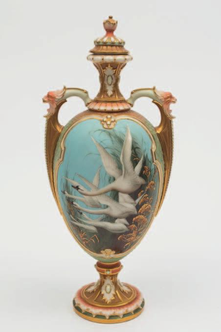 604 A Royal Worcester porcelain two handled vase and cover decorated by Charles Baldwyn of slender oviform, the handles with grotesque masks, enamelled with five swans in flight and
