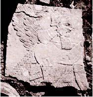 (Fig. 2). This bas-relief is the upper 60% of a slab from the West Wing of the palace, preserving a figure of a human-headed genius before a sacred tree with two ranks of palmettes.