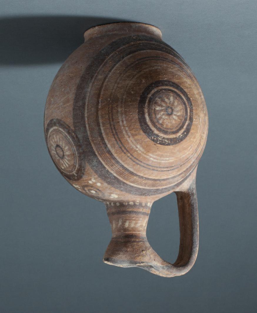 24 43 Cypriot bichrome ware jug, spherical body with ring base and trefoil lip, the handle composed of two conjoint strips.