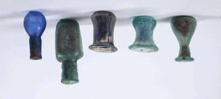 65 Roman sprinkler flask, mould blown in olive-green glass, bulbous body with fine spiral ribbing, flaring mouth and rolled rim, trail around neck, indented base with pontil mark. 3rd-4th century AD.