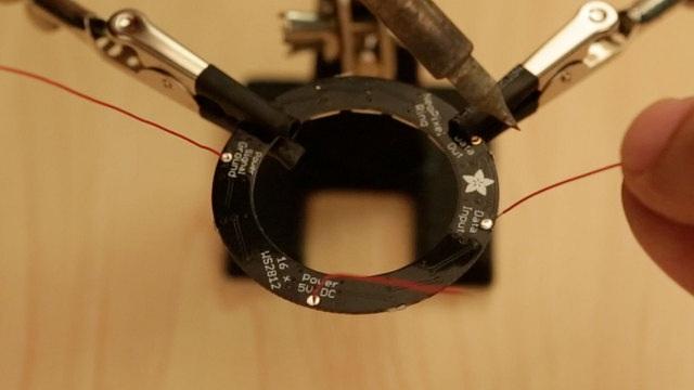Once the mic sensor and NeoPixel ring have the wires securely soldered, use the handy tool to hold the