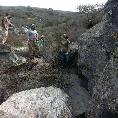 Wendy Teeter (right) and several students record rock art located in one of the island s many drainages.