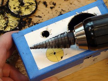 Using the step drill bit, drill each of the remaining eight holes to the size printed on the drilling guide.