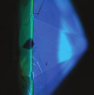Figure 6. This DiamondView image shows a clear distinction between the table/girdle facets (yellow-green, H3 defect) and the pavilion facets (blue, N3 defect).