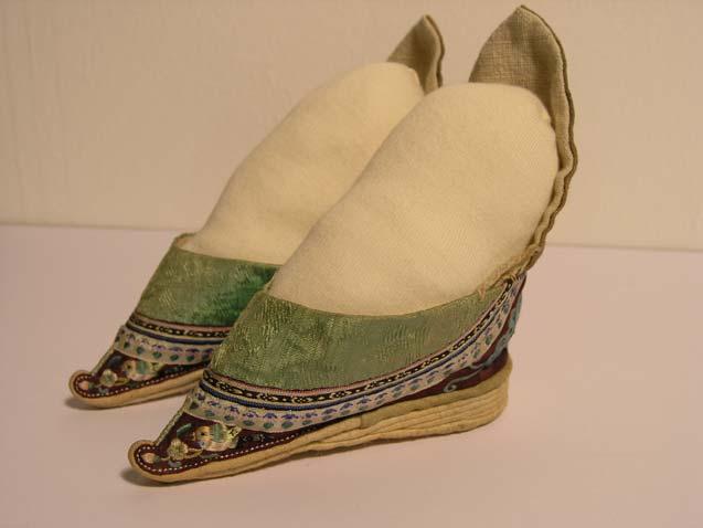 Silk embroidered shoes China These tiny shoes are not those of a baby but of a fully-grown adult woman. For thousands of years, Chinese women practiced foot-binding.