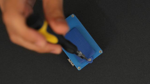 Press the protrusion on the clip into the slot until the screw mount pushes up against the back of the enclosure Secure