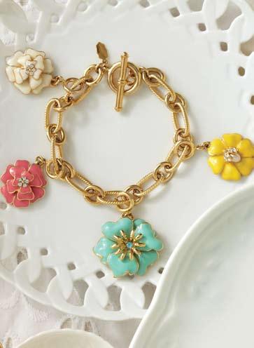 a b As seen in LA Times c a. Bloom Charm Bracelet 14kt gold plated charm bracelet with a white hand-painted flower charm adorned with Czech crystals. 7.75 length. Charm,.75".