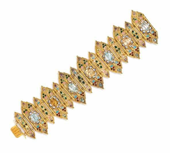 10 9 11 9 a Gothic Revival 18 Karat Yellow Gold, topaz and Polychrome Enamel Bracelet, consisting of four oval mixed cut blue topaz and three oval mixed cut yellow topaz all measuring from