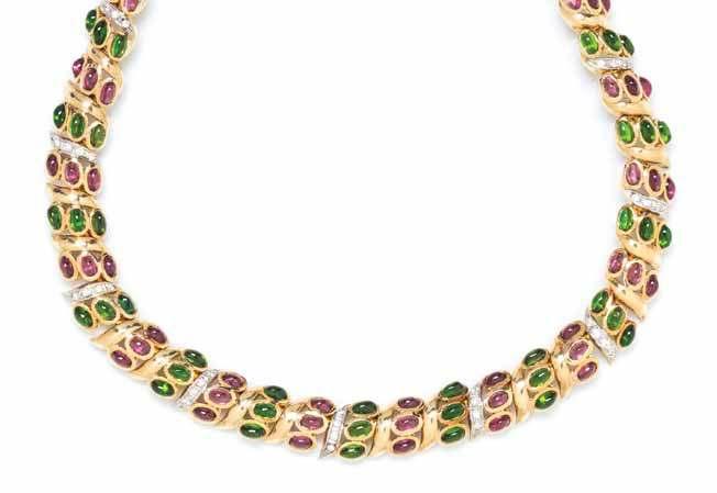 391 392 393 391 a Yellow Gold, tourmaline and diamond necklace, in a repeating S shape link design containing 63 oval cabochon cut green tourmaline measuring approximately 4.92 x 3.