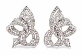 117 118 119 117 a Pair of Platinum and diamond dress clips, in an openwork ribbon motif with millegrain edgework, containing two old European cut diamonds weighing approximately 1.
