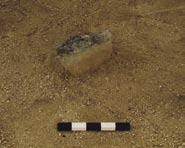 36 m) filled with midbrown silty sand. Three stones, two upright and one angled steeply down arranged in a rough v -shape (l. 0.14 0.22 m; th. 0.03 0.05 m; protrude up to 0.15 m). AK1.83 Post hole (0.