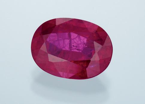 Figure 7. To produce a novelty, flame-fusion synthetic rubies and sapphires can be easily cut from areas within a boule where near-colorless portions join with the colored overgrowths.