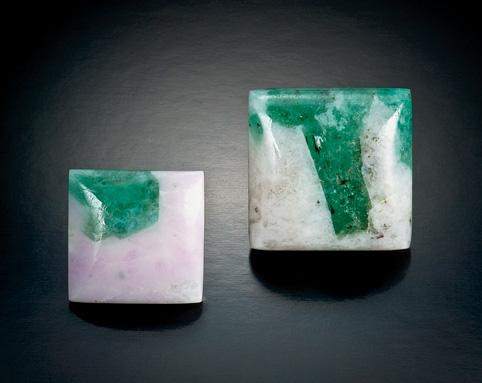 Figure 16. Attractive cabochons of emerald-inmatrix (here, 15.27 and 34.37 ct) have recently been produced from material mined in Bahia, Brazil. Photo by Robert Weldon.