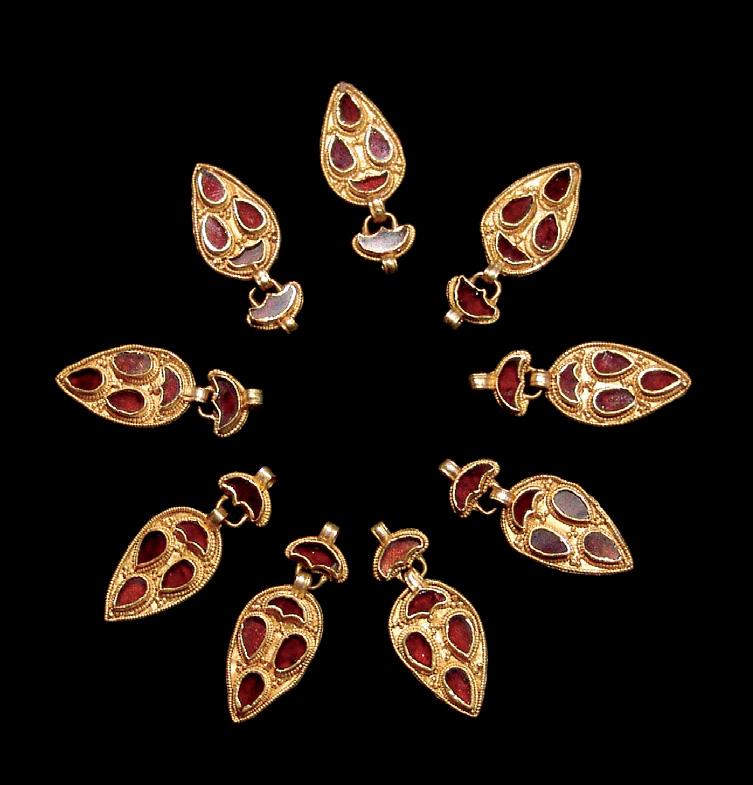 Figure 17. These 5th century gold and garnet pendants (~3.85 cm long) were discovered near Cluj- Napoca, Romania. Photo by C. Ionescu. tals had developed fracture cleavage, as described by J.