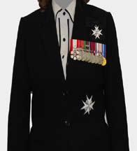If in possession of only one such award, it may be worn on a bow. Only one full-size neck badge should be worn. This should be worn on a bow above the medal bar on the left shoulder.