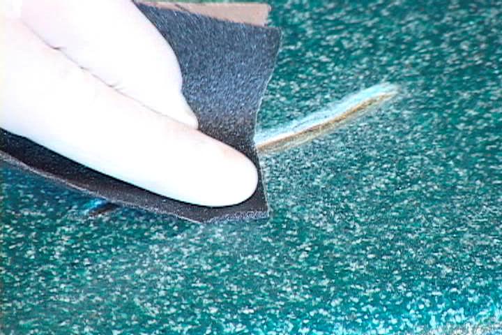 2) Remove all loose fragments from the edge by sanding with 100 grit wet or dry sandpaper. Control the sanding to the immediate area of the defect to minimize the size of the repair.