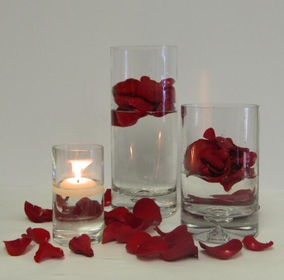 Rose Petal Vases Flowers/Supplies needed: 1 12 x 4 cylinder vase 1 8 x 4 cylinder vase 1 6 x 3 cylinder vase 3 Red roses 1 2 floating candle Instructions: 1. Fill vases with water at different levels.