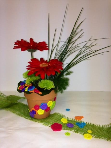 Button UP Mom Flowers/Supplies Needed: 2 Brightly colored gerber daisys 2 Stems of athos spray mumsd 3 Galayx leaves 3-4 Sprigs ming fern 1 4" clay pot 1 4" deep plastic liner ¼ ½ Block wet foam Bag