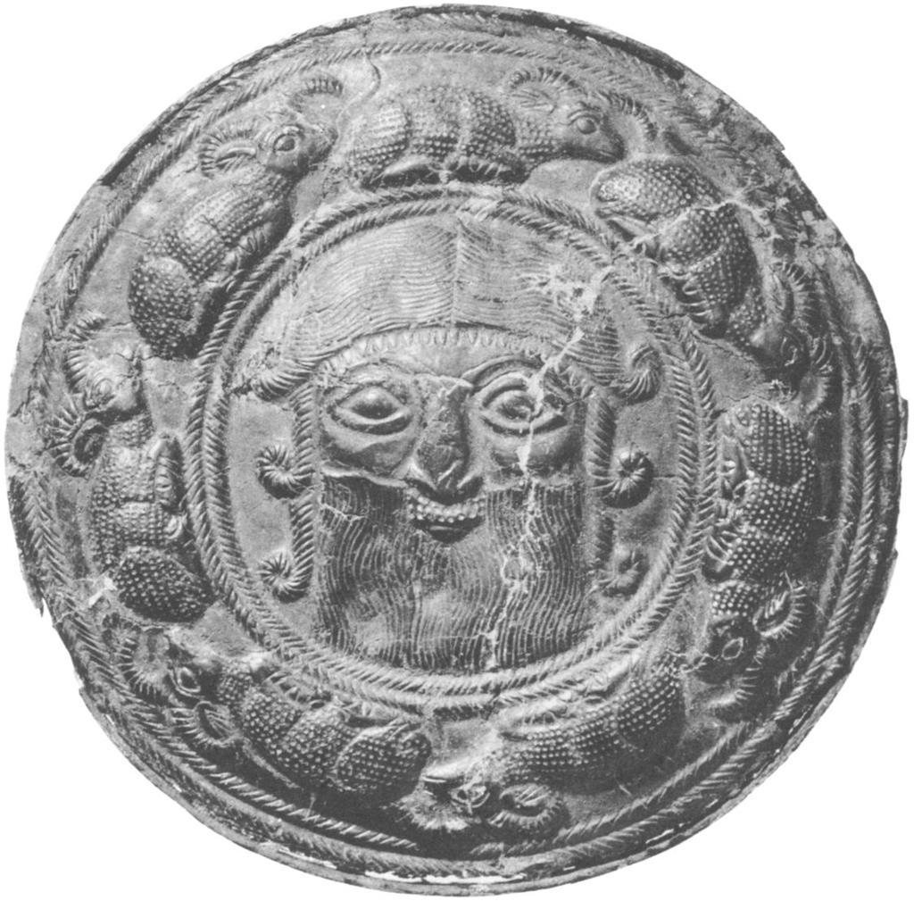 ticularly interesting center decoration: a head with an extremely broad face, short nose, small mouth, low forehead, heavy-lidded eyes, and short beard.