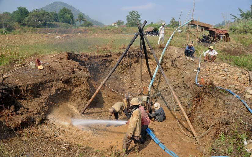 Figure 16: Ruby mining using high pressure water and a jig in O Beng area, Pailin. The jungle covered volcano at the background is Phnum Pod, a volcano which basalts are not known to contain any gems.