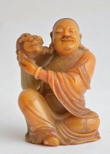 1008 CHINA Steatite sculpture depicting a seated and smiling Luohan with a dragon on the right shoulder. H: 9cm - 3.