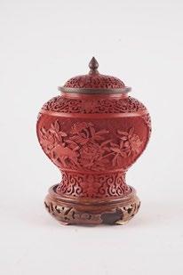 1018B CINNABAR Cinnabar covered vase decorated with embossed vegetal motifs and scrolls, resting on a