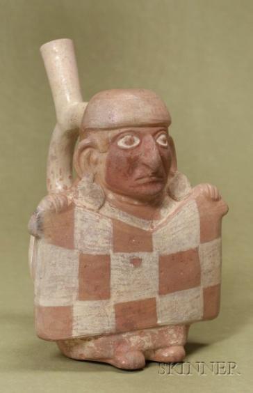 101 Figure 38: Moche stirrup-spout bottle of merchant holding up a checkerboard garment (http://www.skinnerinc.com/auctions/2376/lots/35).