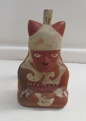 195 A stirrup-spout bottle of a human figure with fox ears on his headdress at the Field Museum, is described as a vessel and was accessioned in 1904.