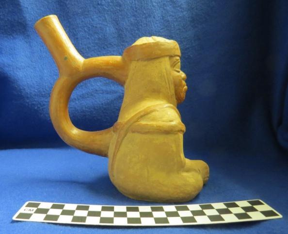 How Acquired: Purchase Remarks: blank Author s Description: Red and cream-colored stirrup-spout bottle of seated man with bottoms of feet touching and hands on knees.
