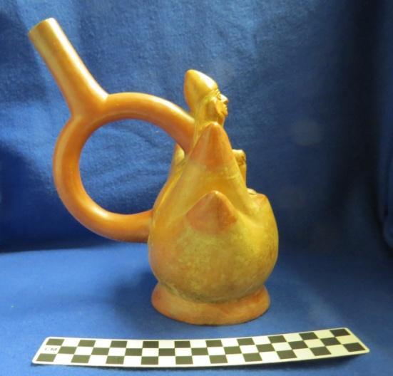 How Acquired: Exchange Remarks: Exchanged for: 52271/18046 + 37860/10164; Stamp B. Brown 1979 Author s Description: Red and cream-colored stirrup-spout bottle of elite figure sitting on a mountain.