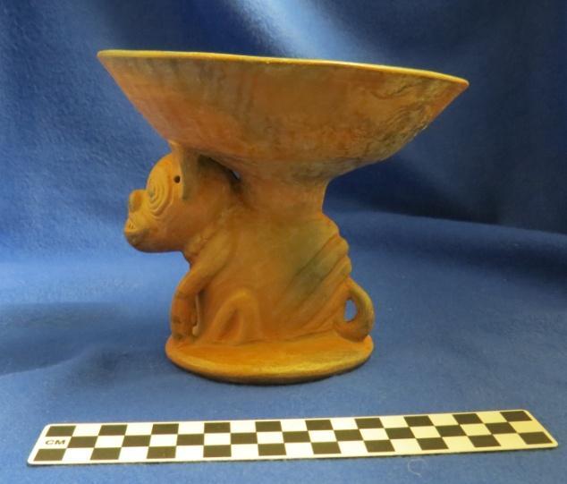 294 Catalog: 54633 / Accession: 20517 Catalog Information: Catalog Book #: 12 Date of Entry: January 4, 1967 Name and Description: Shallow bowl on animal effigy of dog. dia. 17.2 cms height 14.