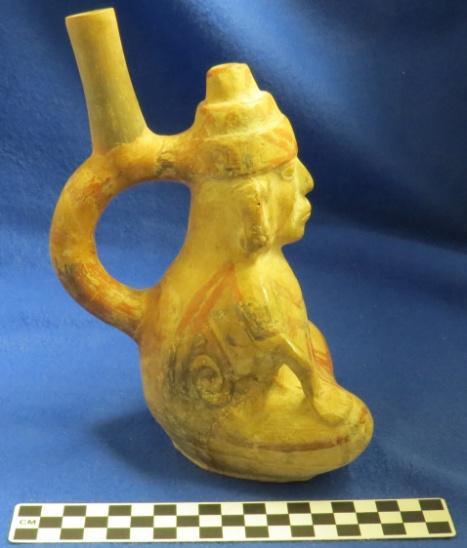 297 Catalog: 56692 / Accession: 22561 Catalog Information: Catalog Book #: 13 Date of Entry: May 18, 1971 Name and Description: Effigy pot with stirrup spout, shaped like a sitting person, beige with