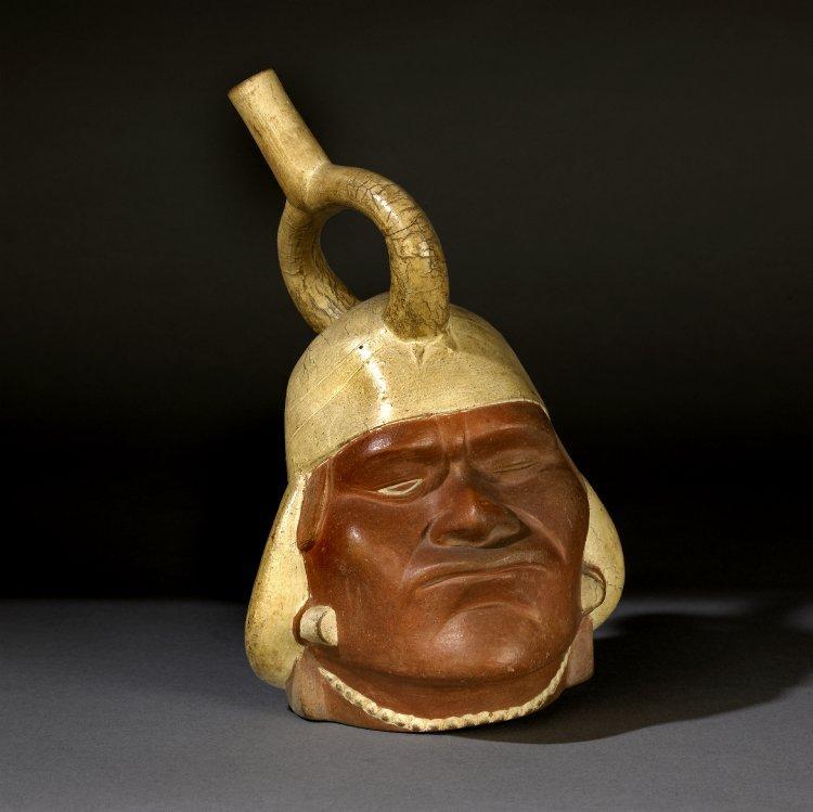 354 Object: Am1880,0405.1 Object type = vessel Description = Stirrup spout vessel (headshaped) made of pottery.