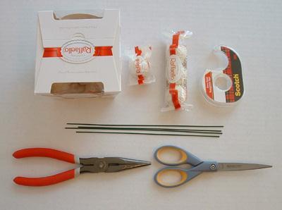 b) Bend stem wire into a V shape and attach the bottom of the V to a Raffaello candy using clear packing tape.