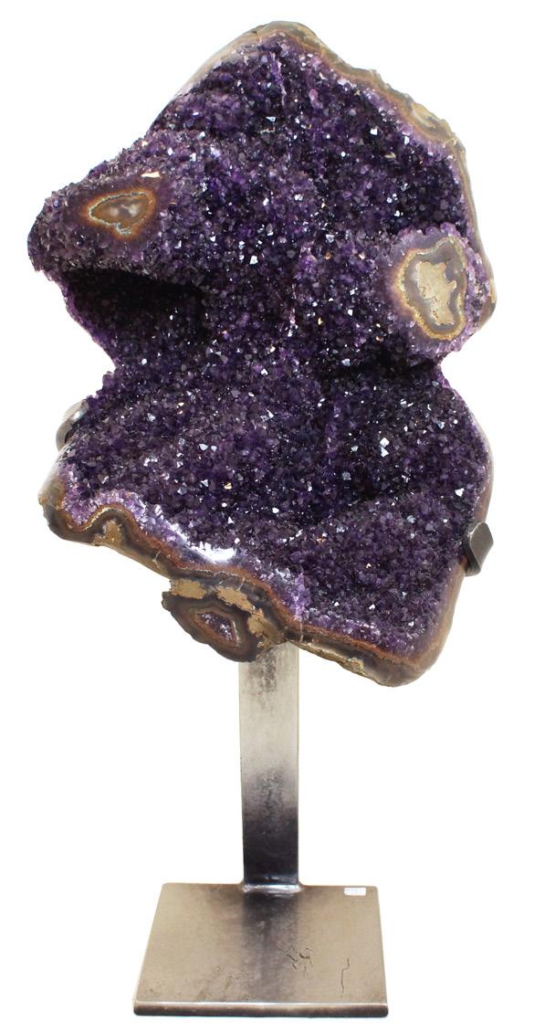 AMETHYST GEODE This amethyst cluster originates from the city of Artigas in the Uruguayan department of Artigas. Two agate eyes on either side of the cluster make this a truly unique piece.
