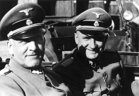 [Image] Oswald Pohl (left) with Commandant Richard Baer (right) during an official visit to Auschwitz by automobile.