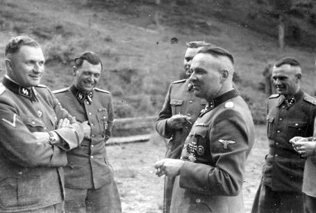 claims that anything like two and a half or three million people perished in Auschwitz. [Image] Rudolf Höss (center front) in happier days.