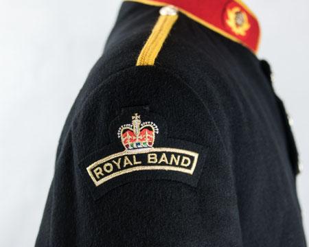 shoulder seam ROYAL BAND shoulder flash: Embroidered letters surmounted by a crown (gold on dark blue) Below right shoulder (Note 1) - centrally, top edge of badge 20mm below shoulder seam
