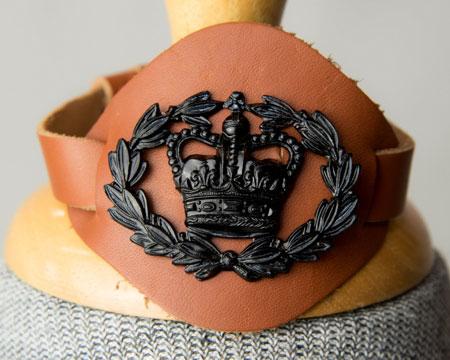 WO2 badge: Crown in laurel wreath on a slide (black on olive) Shoulder straps (rank slide) Effective October 2017 WO2 rank badge: Crown in laurel wreath (bronze) on a brown wrist strap Right wrist -