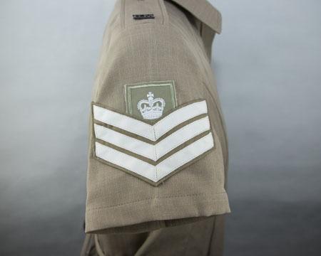 Bugle Major appointment badge: Four inverted chevrons surmounted by a bugle (chrome) on a brown wrist strap Effective October 2017