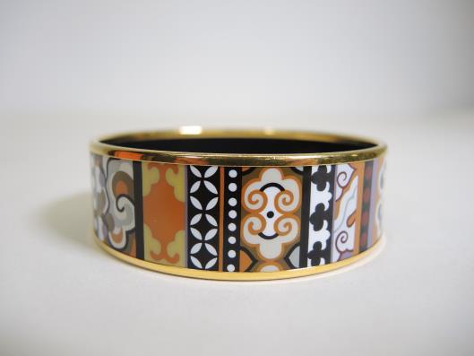 HERMÈS Orange, Black and White Enamel Bangle Retails for $550, sold in one day for $349. 09/30/17 Adorn your wrist in this highly detailed mosaic designed enamel bangle in rich fall colors.