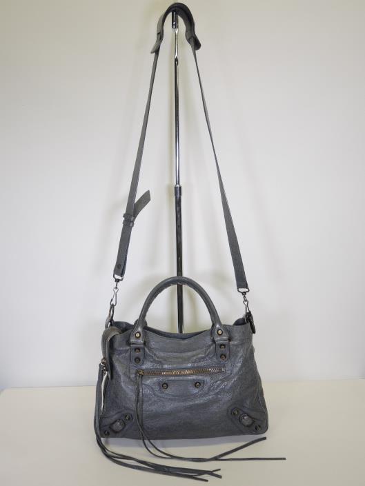 BALENCIAGA Grey Town Crossbody Retailed for $1765, sold in one day for $699. 08/05/17 A purse that will live easily under your arm is this pre-distressed leather cross body bag from Balenciaga.
