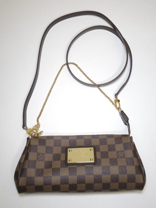 LOUIS VUITTON Eva Crossbody Retailed for $825, sold in one day for $499. 06/10/17 Classic brown Damier check print covers this petite purse from 2009 that can be used three ways.