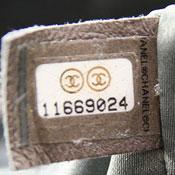 "x" cut-lines prevent sticker from being removed without damage. "CHANEL" appears on right right side of the sticker. Dark line appears on left side of sticker.