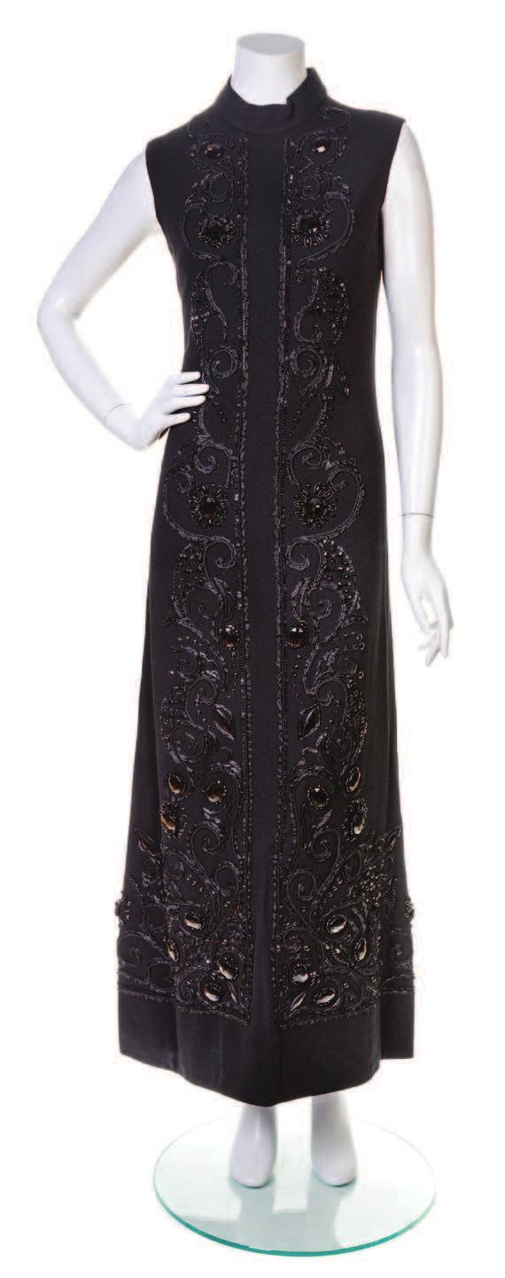 51 A Balenciaga Black Crepe Evening Gown, 1960 s, sleeveless with a high neck collar and elaborate, heavy black beadwork and a back zip closure.