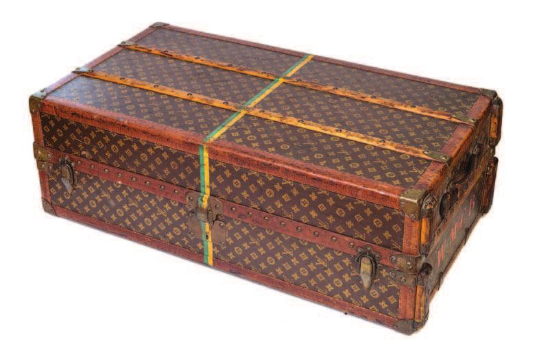 81 A Louis Vuitton Vuittonite Leather Steamer Trunk, 1915, with a hinged top and side which open to reveal a built in cupboard, four fitted drawers, a basket and thirteen hangers.